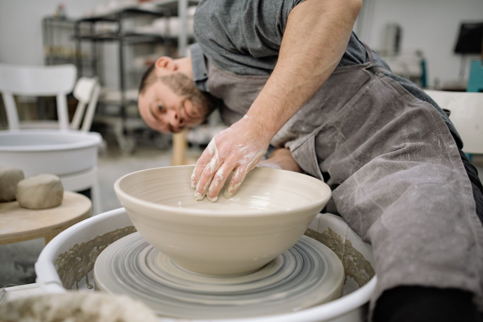 Ceramic bowl being shaped on a pottery wheel